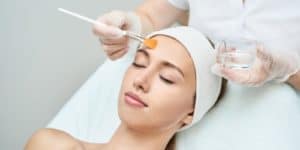 Young woman receiving a non-invasive cosmetic procedure.